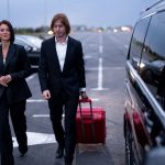 business-couple-walking-with-suitcase-parking-lot