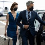 elegant-businessman-with-assistant-with-suitcase-is-coming-by-car-airport-runway-flying-duri