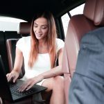 female-entrepreneur-working-travelling-office-luxury-car