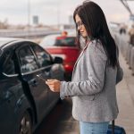 happy-caucasian-woman-traveller-airport-terminal-is-taking-taxi