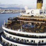 large-cruise-ship-sailing-across-sea-near-harbor-stock-top-view-huge-cruise-ship-sea