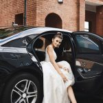 long-legged-brunette-model-girl-with-bright-makeup-trendy-silver-dress-sits-luxury-car