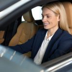 longhaired-blonde-business-woman-steering-wheel-car