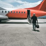 rear-view-man-airport-runway-against-sky